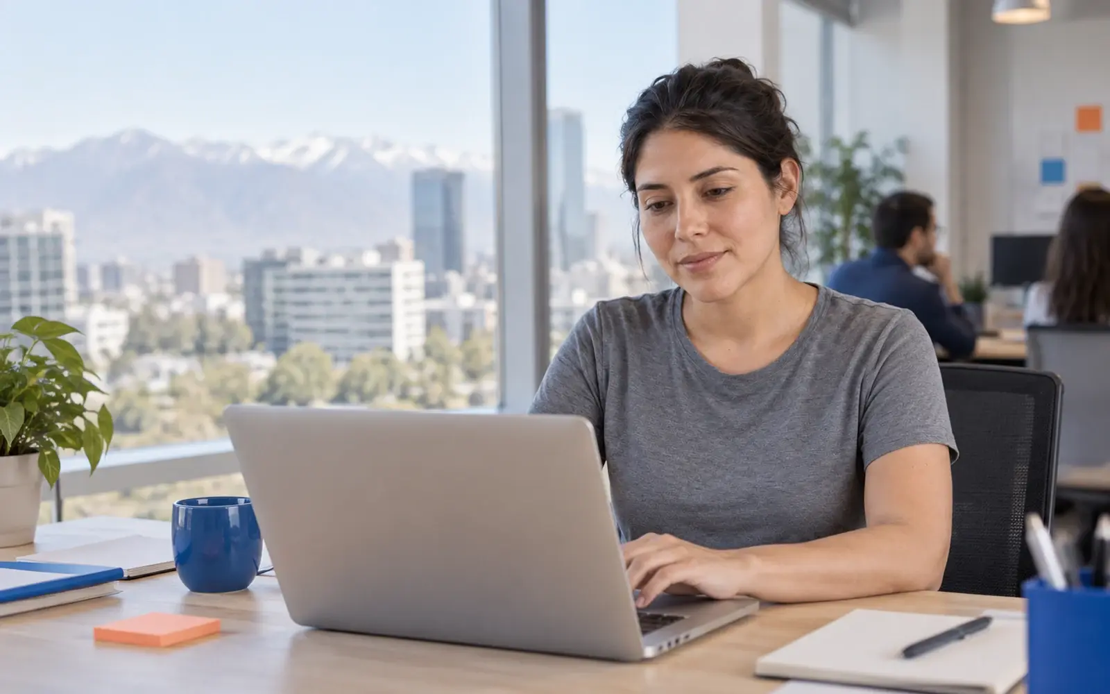 Una persona trabaja en una laptop en una oficina de tecnología.